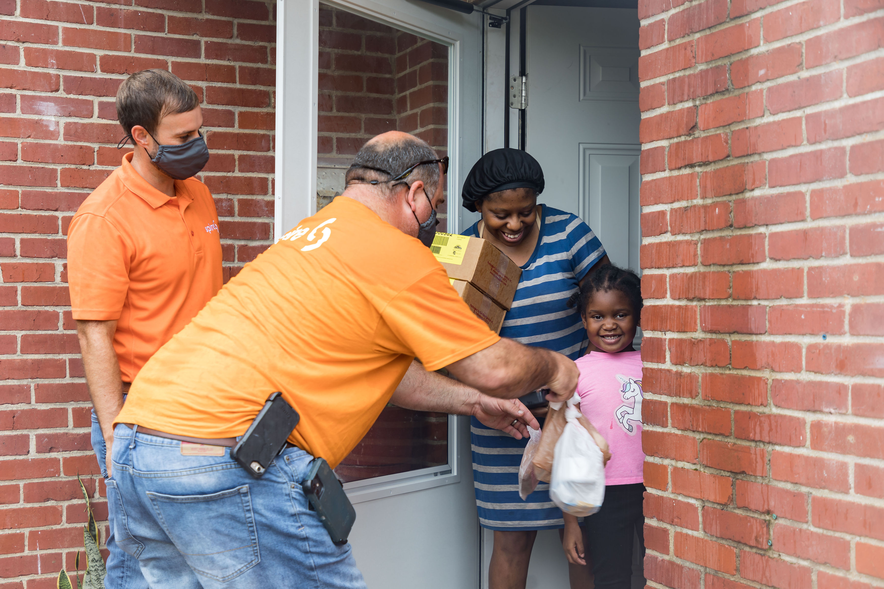 Image of: Spire volunteers with Meals on Wheels delivering food