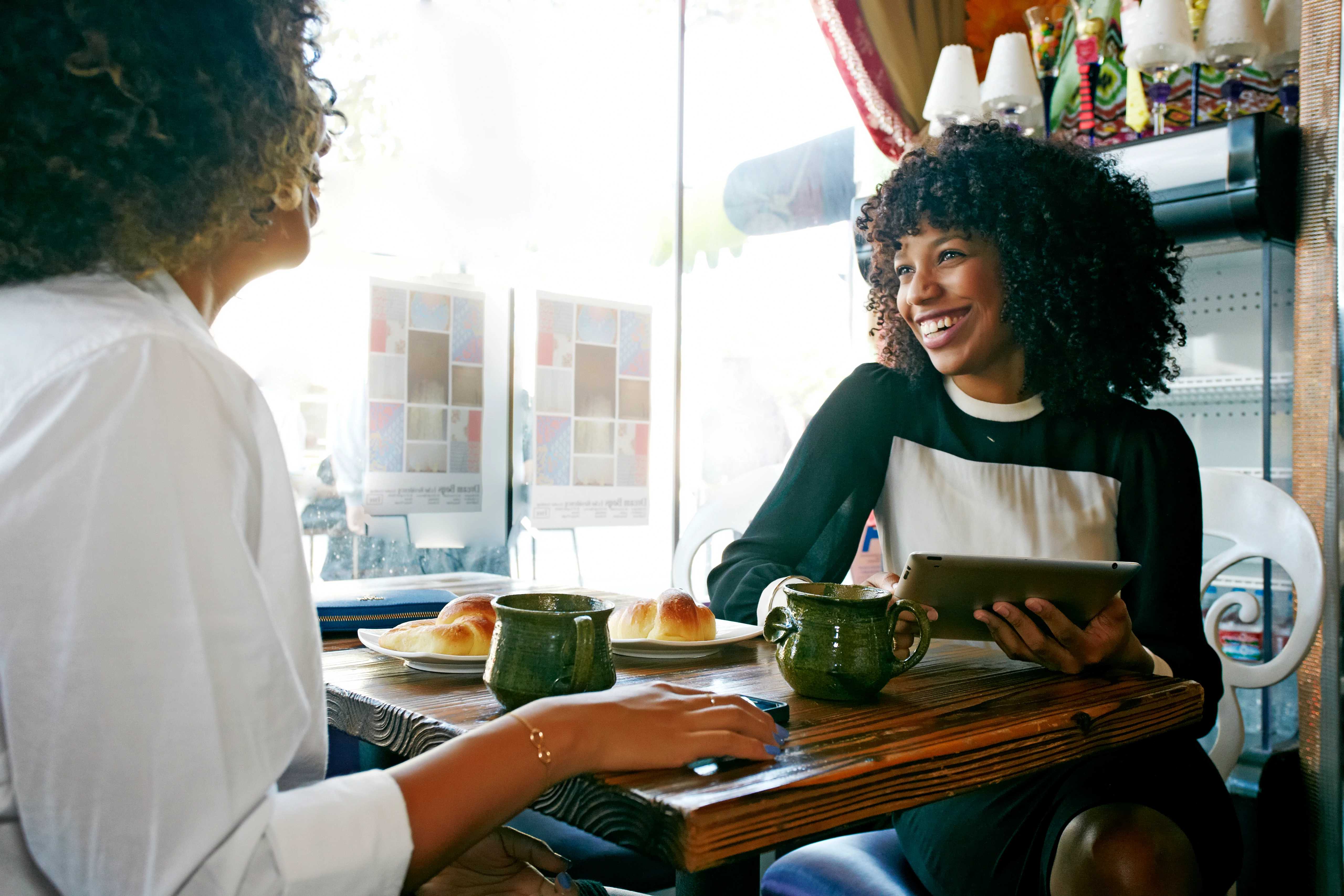 Image of two African American women enjoying a meal at a cafe