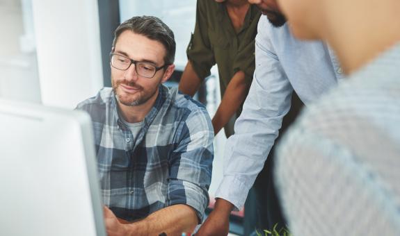 Benefits Business people around computer