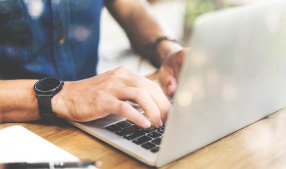 Man typing on laptop