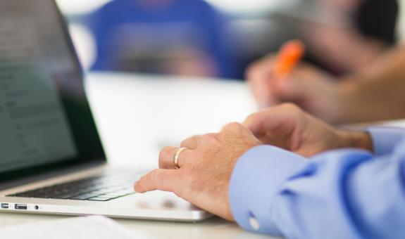 Image of: Man typing on computer