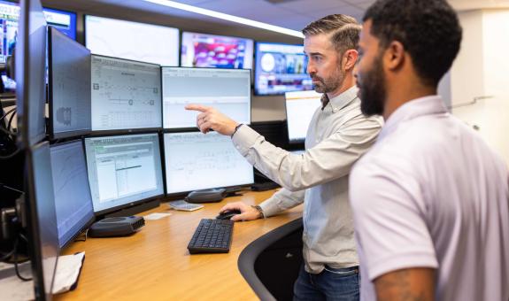 Image of gas supply employees looking at monitors
