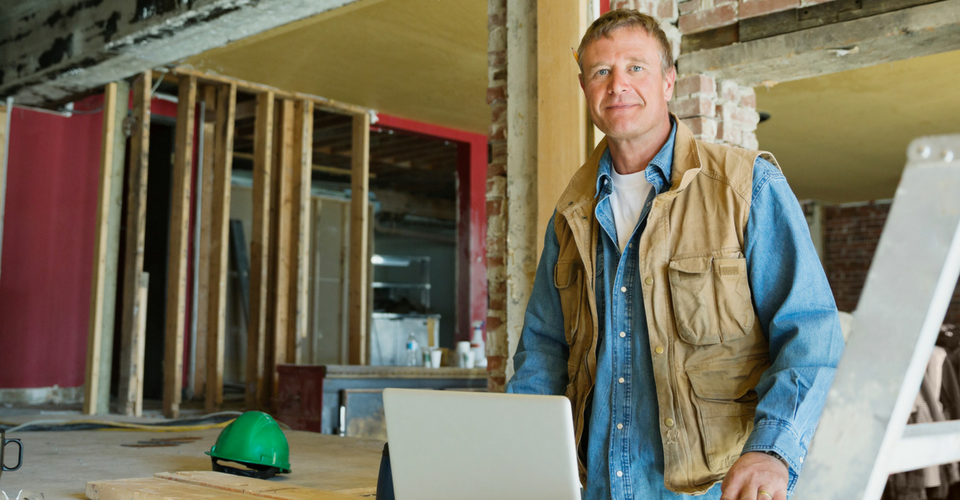 Contractor in front of computer