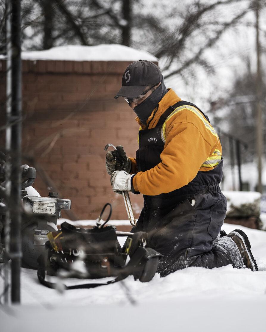 Image of: Spire employee working in snow