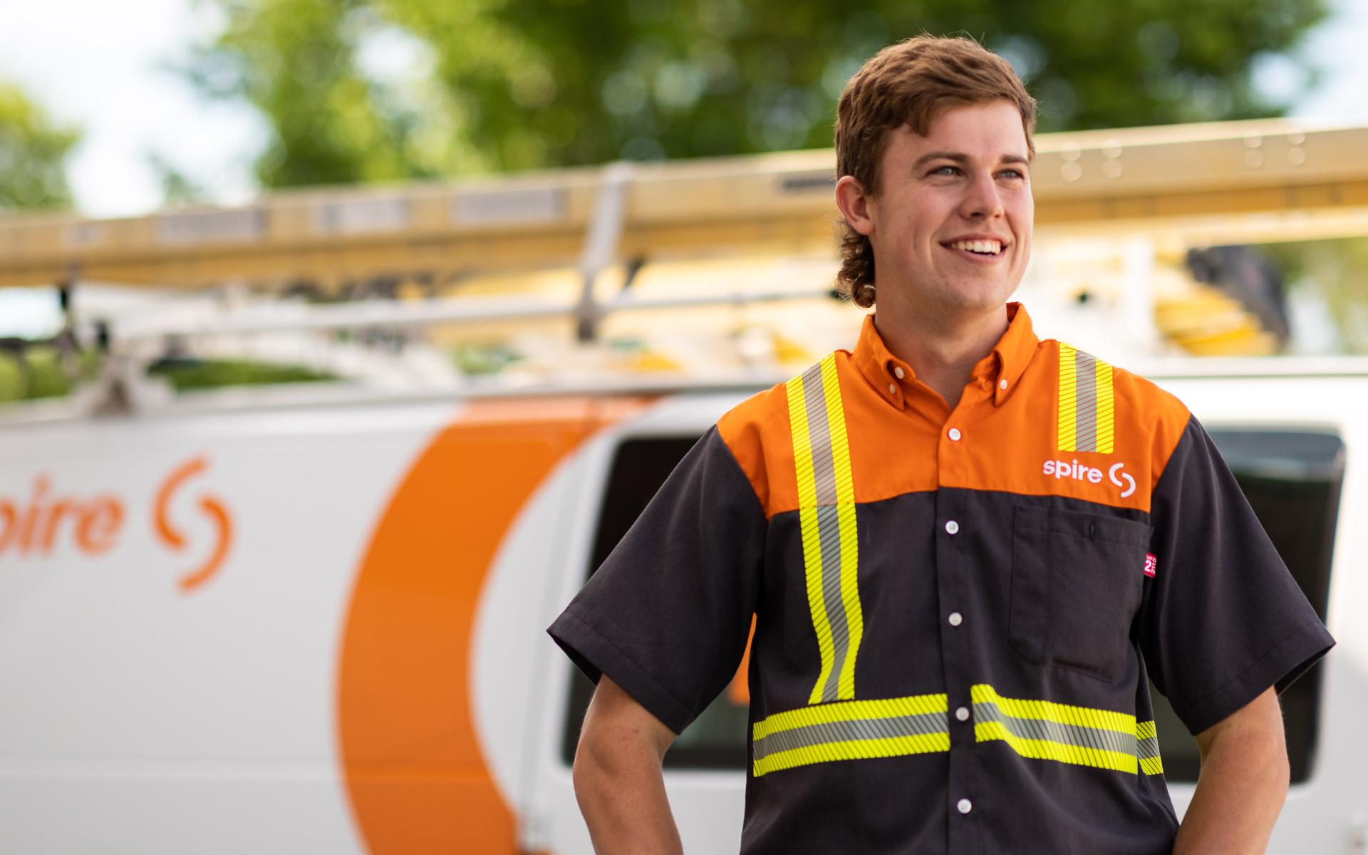 Image of spire co-op student standing in front of a Spire service van