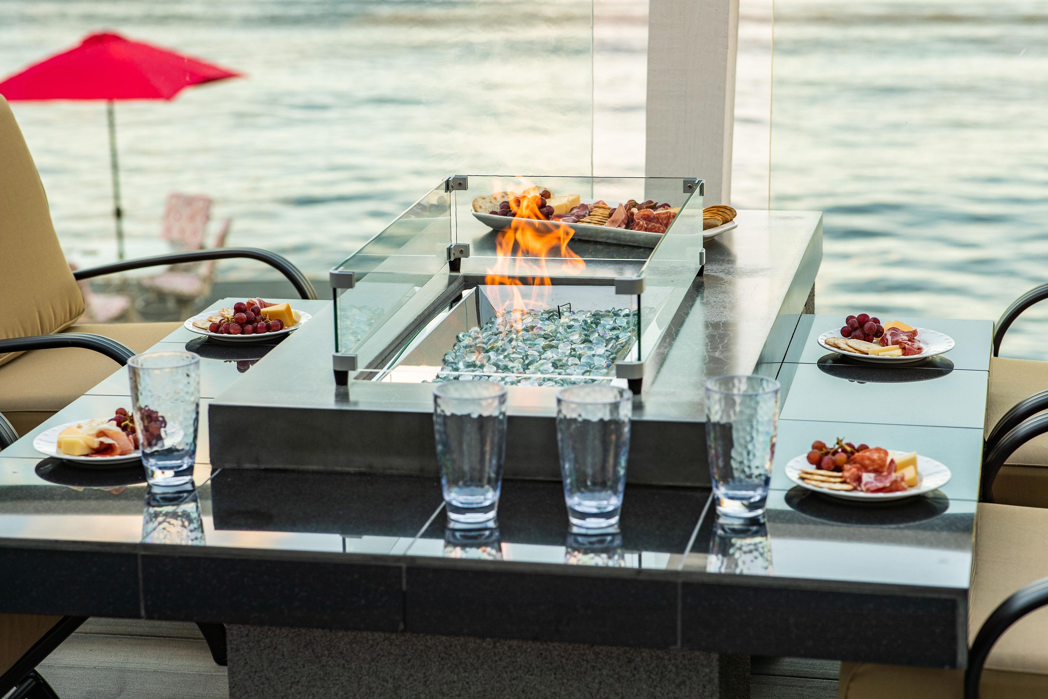 outdoor deck with natural gas fireplace and food 
