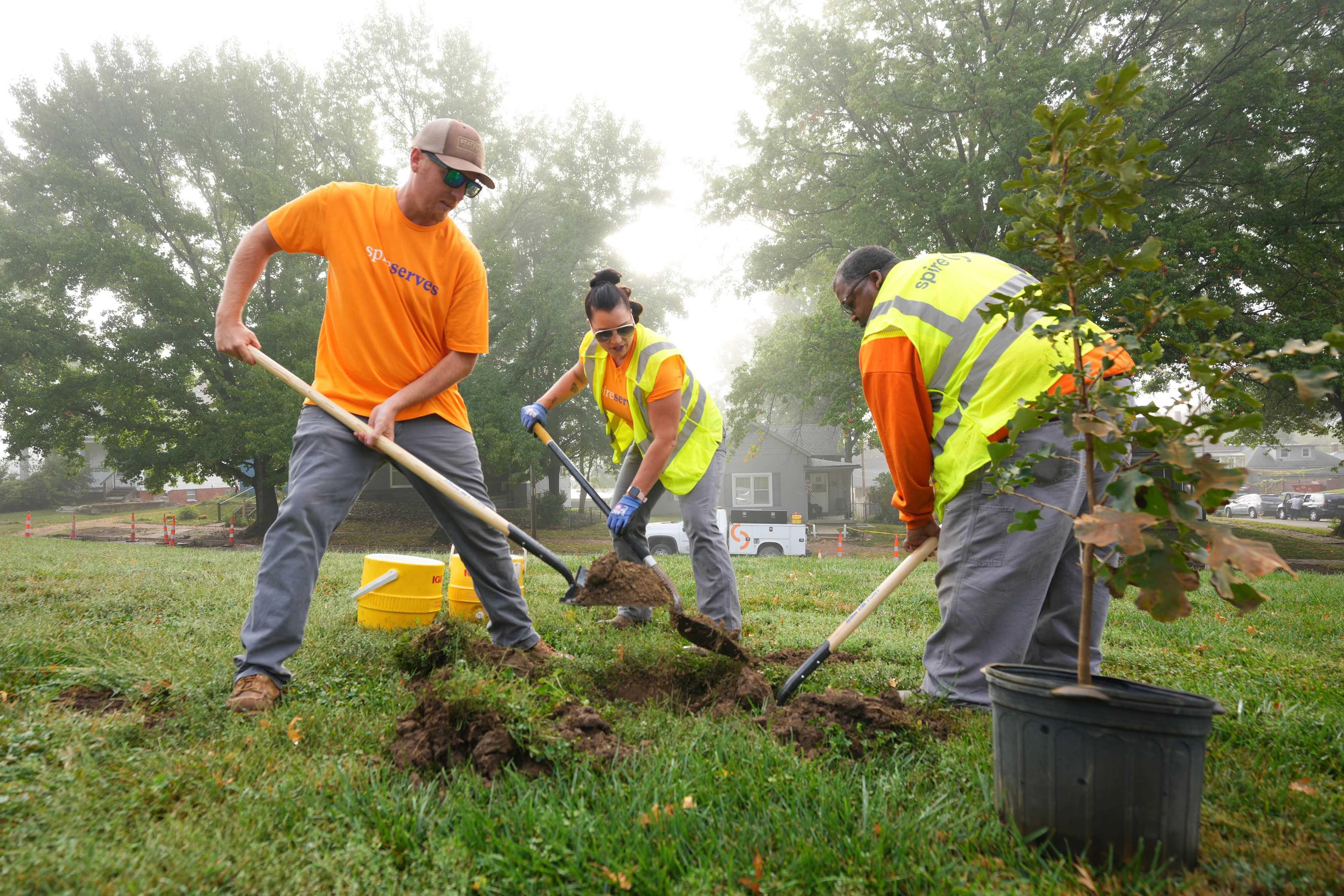 Image of employees planting a tree in St. Joseph, MO