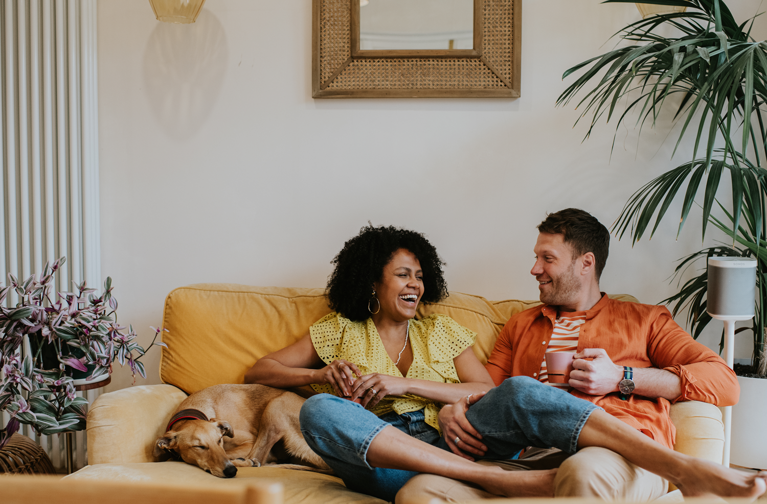 Couple laughs on couch