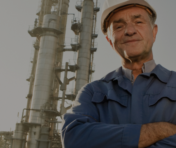 Employee standing in front of factory