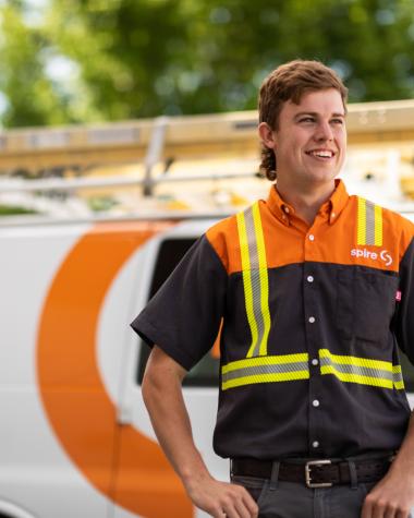Image of Spire service technician in front of Spire service van