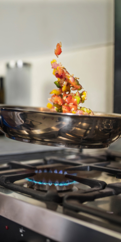 Image of hand tossing a pan