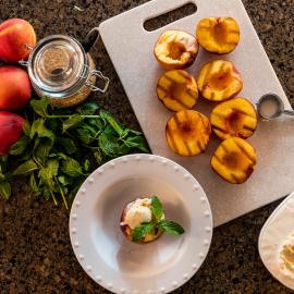 grilled peaches laid out with ice cream and other ingredients
